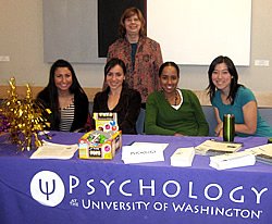 Dr. Kenney with grad student volunteers at McNair grad school fair