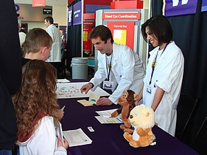 Photo:  Project 1, 2, 3, Go! team members, John Loughlin-Presnal and Kristina Ponischil, had a great time teaching kids about self-control at their booth.