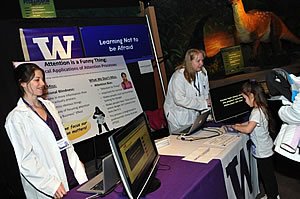 Photo:  Graduate student Alissa Worly (left) and Associate Professor Lori Zoellner teach a child about attentional focus.