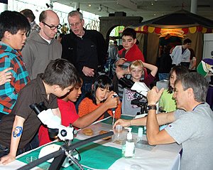 Photo: Professor Randy Kyes (rt) providing exhibit demonstration during the UW Paws-on-Science event