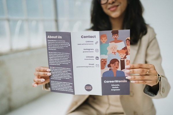 Serah Prakkat holding a brochure for CareerWomin