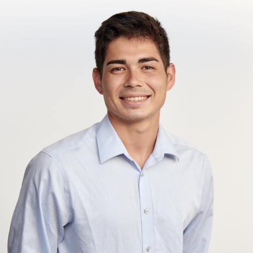 Headshot of Zach Trevorrow in a white shirt and white background