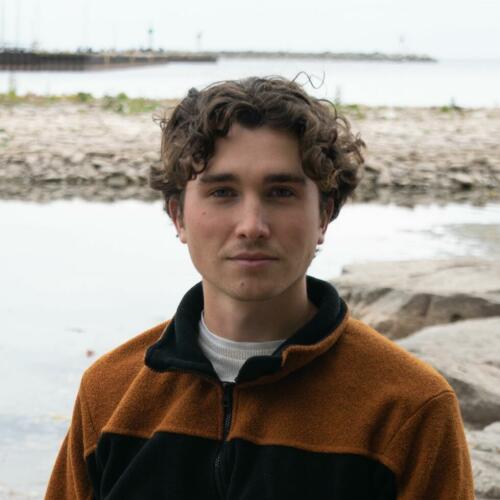 Connor Smith with beach tidepools in the background