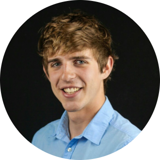 photo of Aric Chandler in a blue shirt against a black background